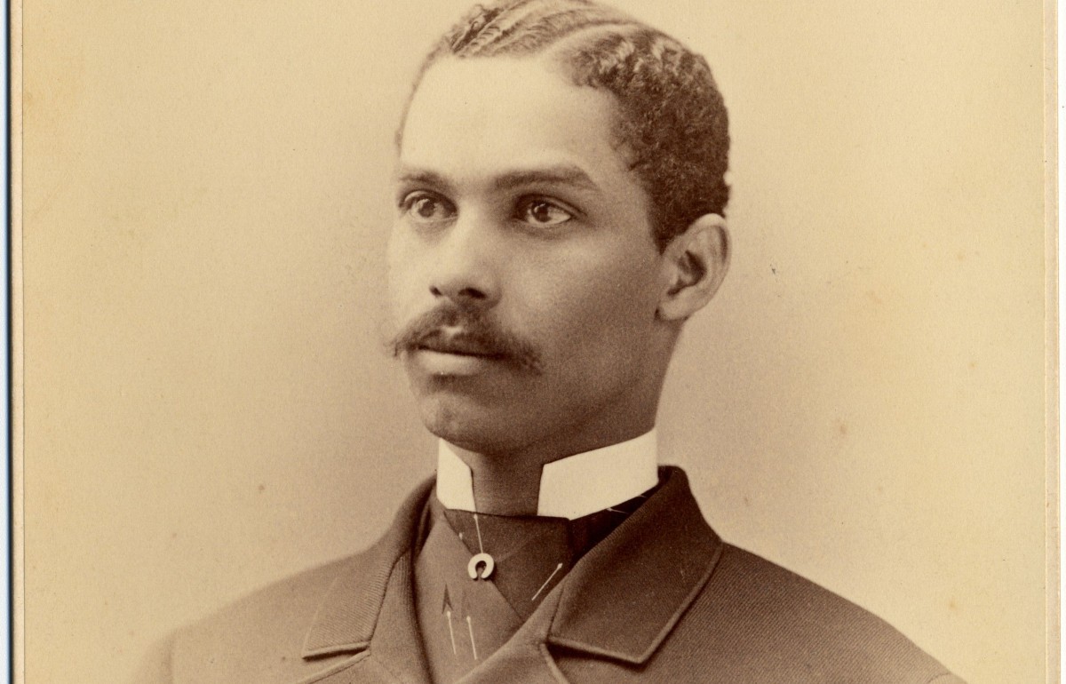 Yellowed photography of a formally dressed black man with a mustache