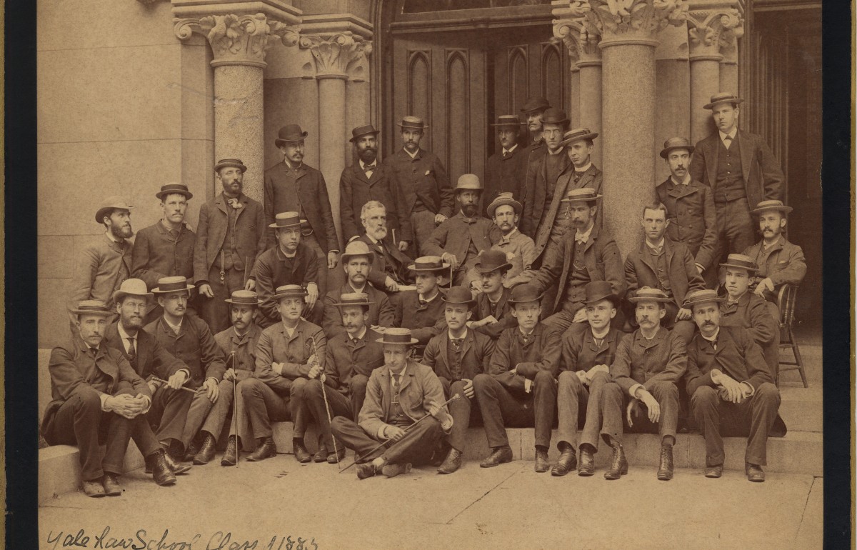 Yellowed scan of a photograph of a group of 19th century law students on stone steps