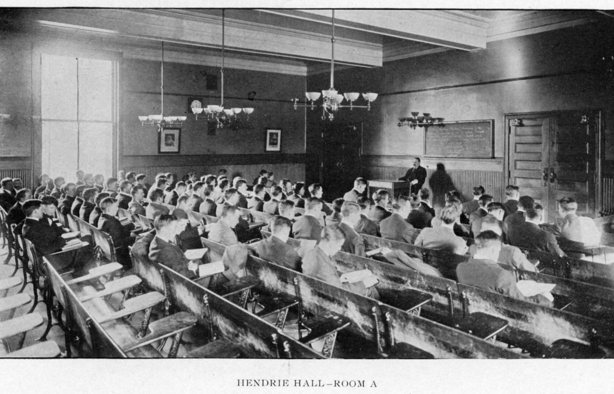 Black and white photograph of a classroom during class. 