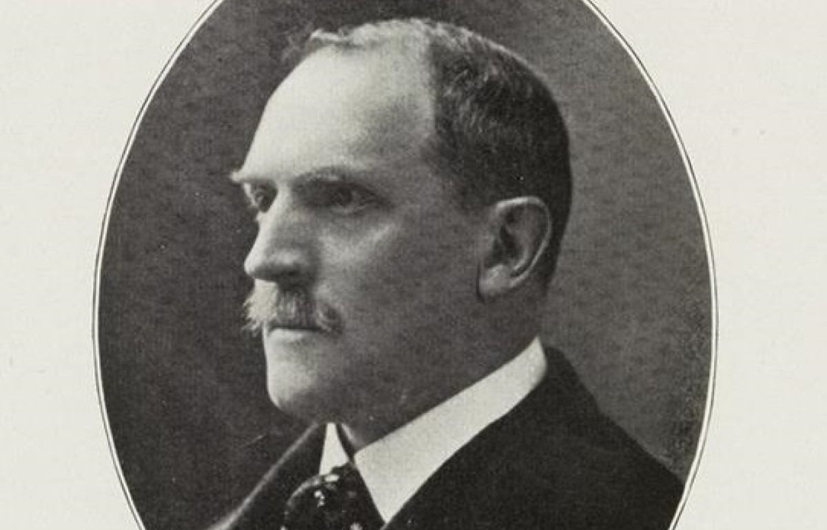 Black and white photograph of a 3/4 profile of a man with a mustache