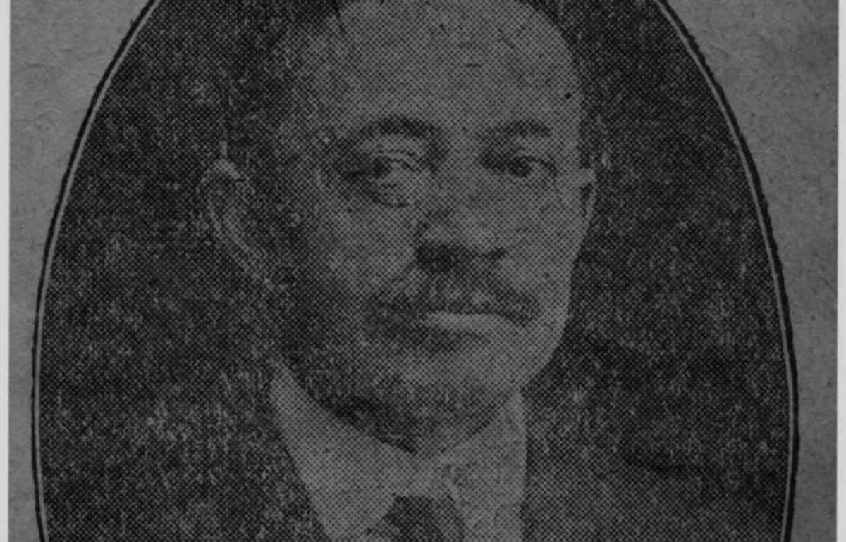 Faded newspaper clipping image of a man 