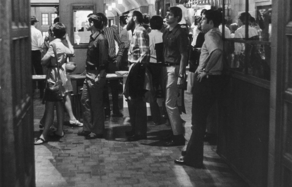 Black and white photograph of a crowd of students in the law school hallway.