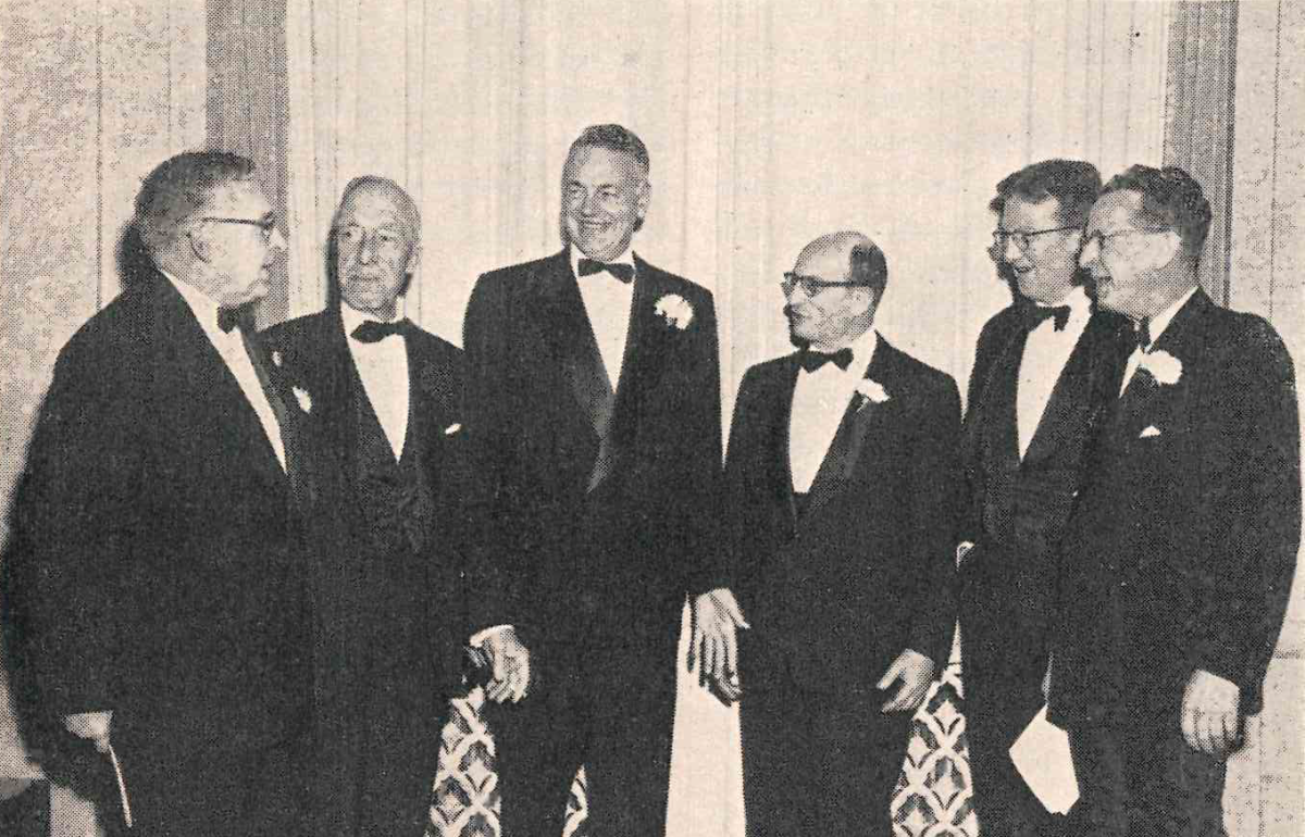 Scan of a photograph of six men in tuxedos.