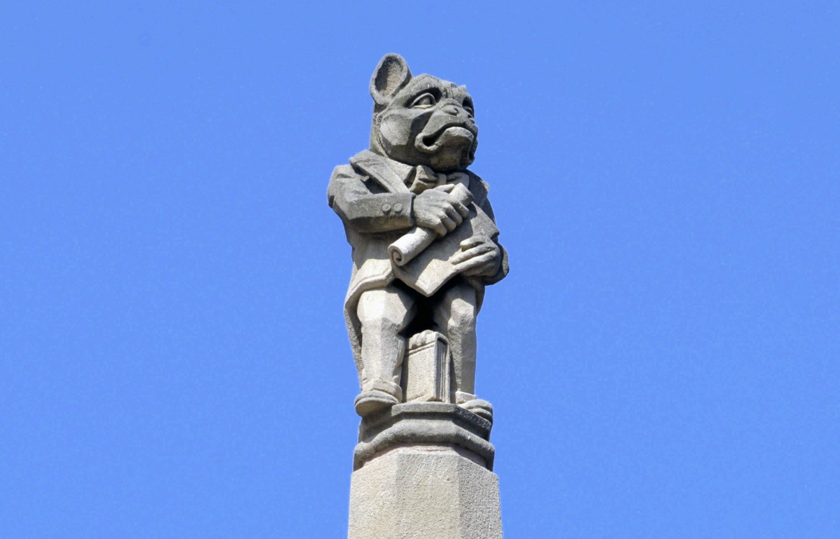 Photograph of a bulldog headed person gargoyle that adorns the outside of the law school.