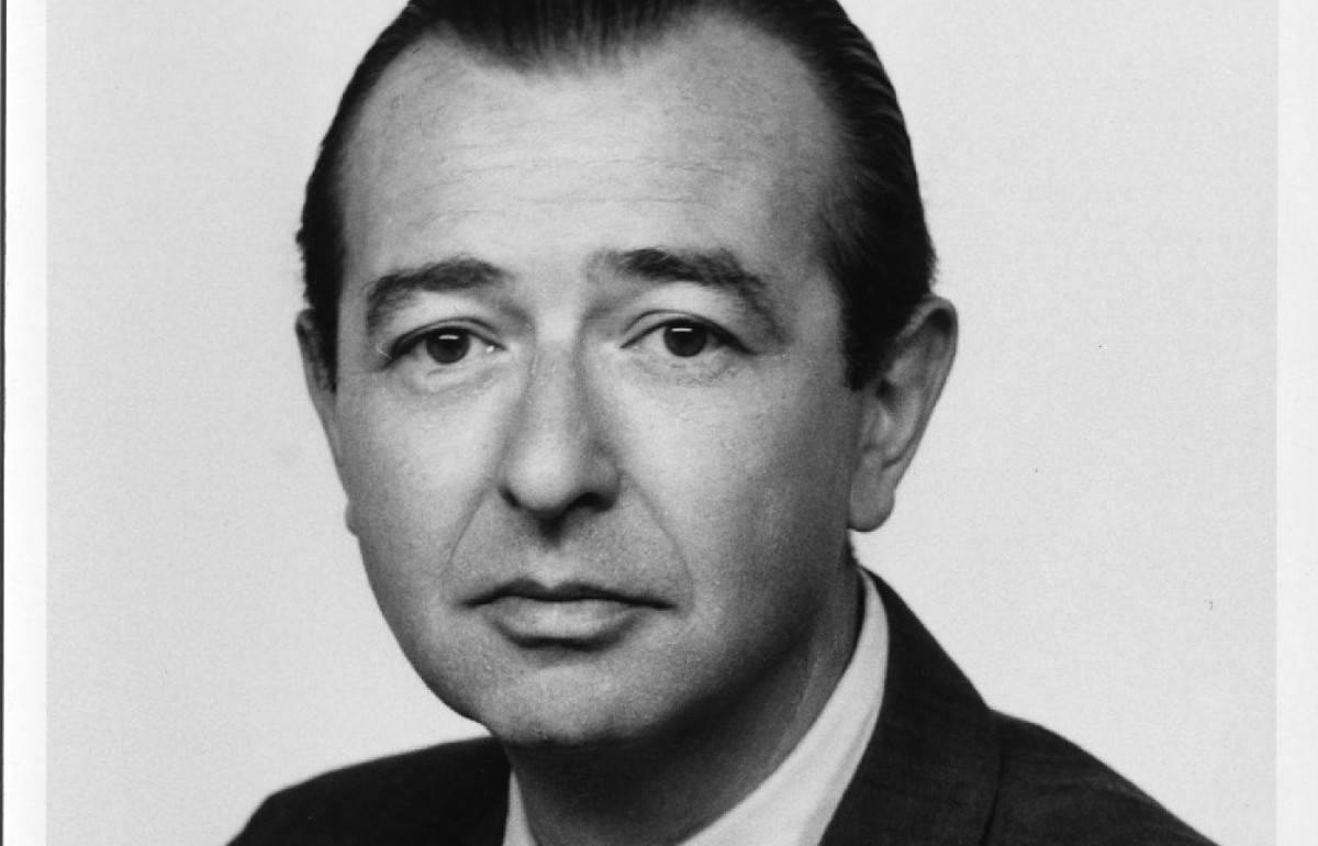 Black and white photograph of a man in a suit