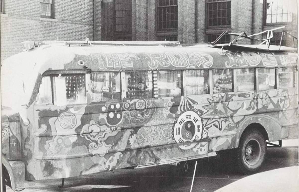 Black and white photograph of a painted 70s bus with the words "The Road Hog" on it