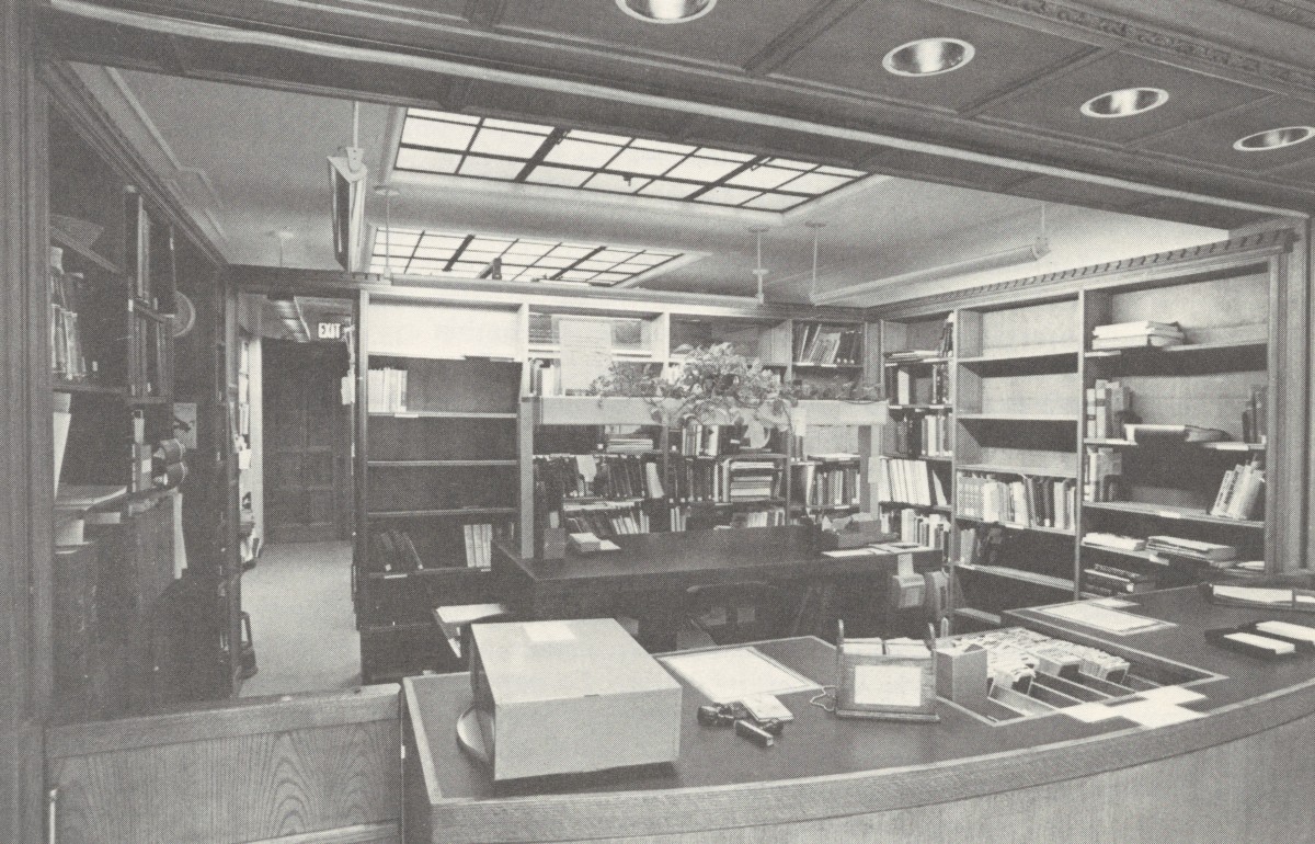 Old photograph of a library circulation desk. 
