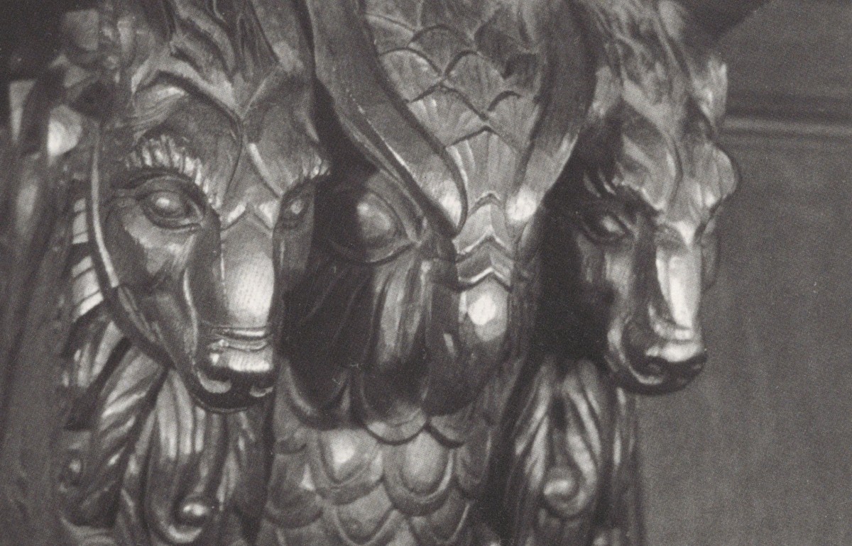 Carved animals in the corner of a doorway.