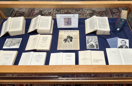 Bird's eye photograph of a display case with a number of books and journal articles.